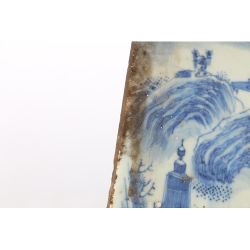 524 - Two 19th century oriental blue and white porcelain tiles, decorated as a mirror image of landscape s... 