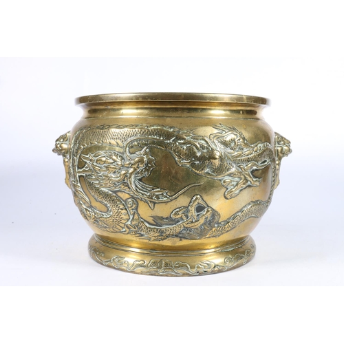 540 - Chinese bronze jardinière with dragons in relief and face mask handles to sides, inscribed 