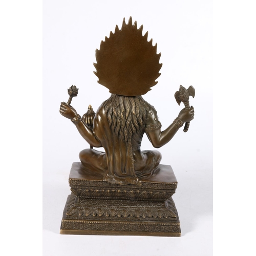 542 - Southeast Asian bronze figure of a seated goddess, 28cm.