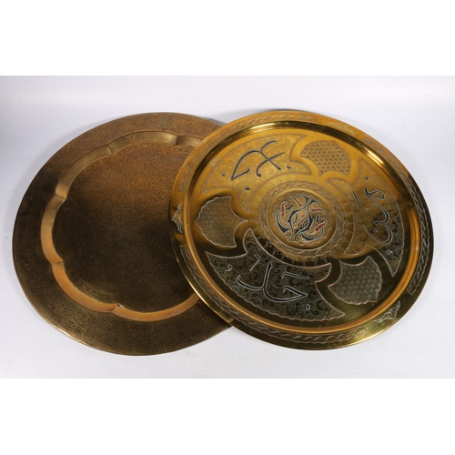 544 - Two brass decorative wall plates, larger with foliate decoration and scalloped well, 50cm dia.