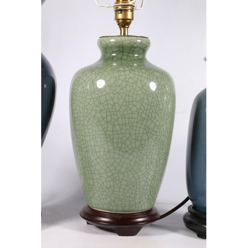 545 - Chinese celadon green crackle glaze effect table lamp with two others, tallest 32cm, on wooden stand... 