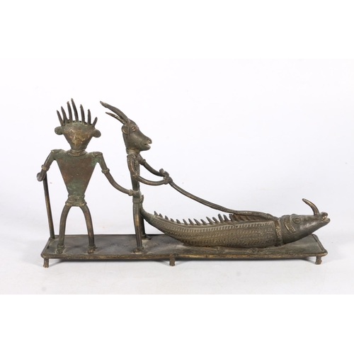 584 - Bronze figural group of two figures with animal heads and a fish/lizard on lead, 20cm high.