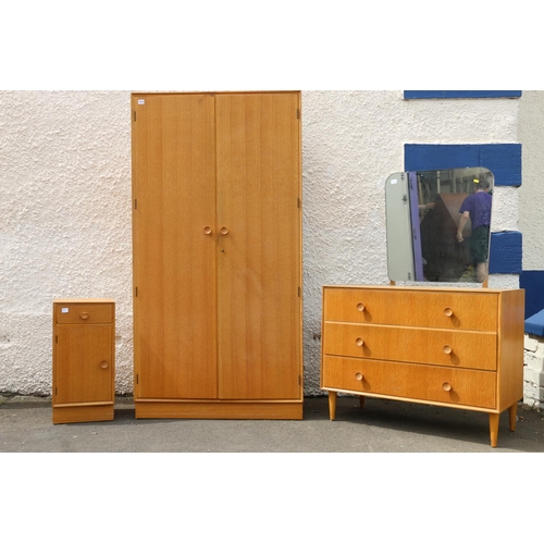 594 - Mid-century oak Meridew four piece bedroom suite comprising a dressing table, a wardrobe, a chest of... 