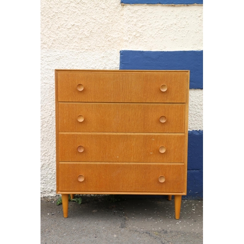 594 - Mid-century oak Meridew four piece bedroom suite comprising a dressing table, a wardrobe, a chest of... 