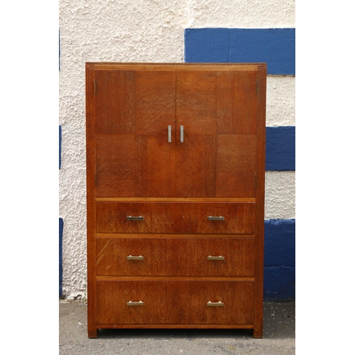 601 - Art Deco limed oak tallboy by Heals of London, the twin-cabinet doors having quarter panel veneer, a... 