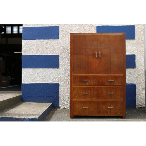 601 - Art Deco limed oak tallboy by Heals of London, the twin-cabinet doors having quarter panel veneer, a... 