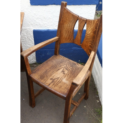 603 - 20th century oak Arts & Crafts style dining table and eight (six plus two) chairs.