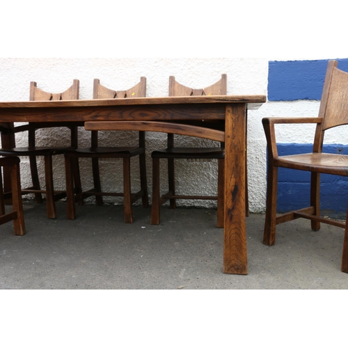 603 - 20th century oak Arts & Crafts style dining table and eight (six plus two) chairs.