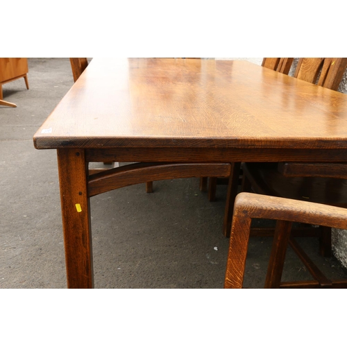 603 - 20th century oak Arts & Crafts style dining table and eight (six plus two) chairs.