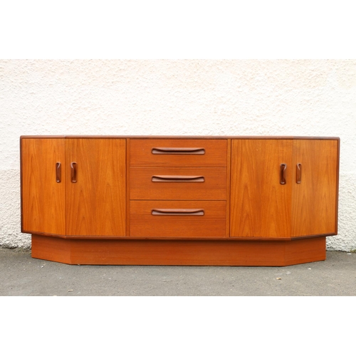 611 - 1960s teak sideboard by G-Plan, the three graduated central drawers flanked by angled twin door cabi... 