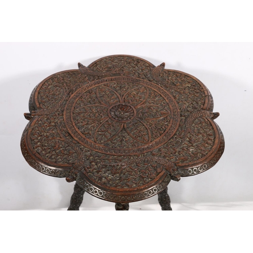 642 - Indian carved table with fish and foliate caved undulating edged top on carved tripod support, 56 x ... 