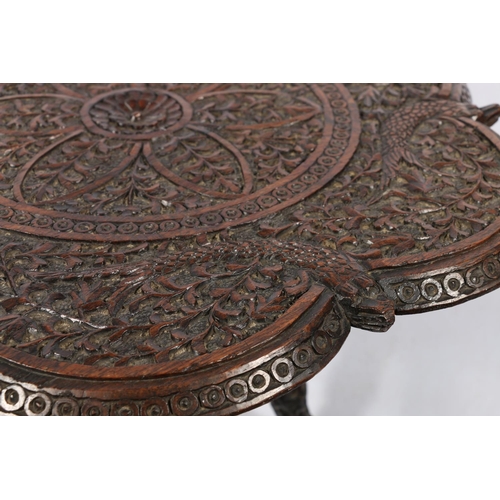 642 - Indian carved table with fish and foliate caved undulating edged top on carved tripod support, 56 x ... 