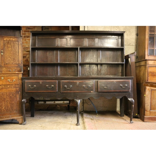 646 - 18th century dresser, the panelled plate rack over base with three drawers, shaped apron, raised on ... 