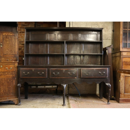 646 - 18th century dresser, the panelled plate rack over base with three drawers, shaped apron, raised on ... 