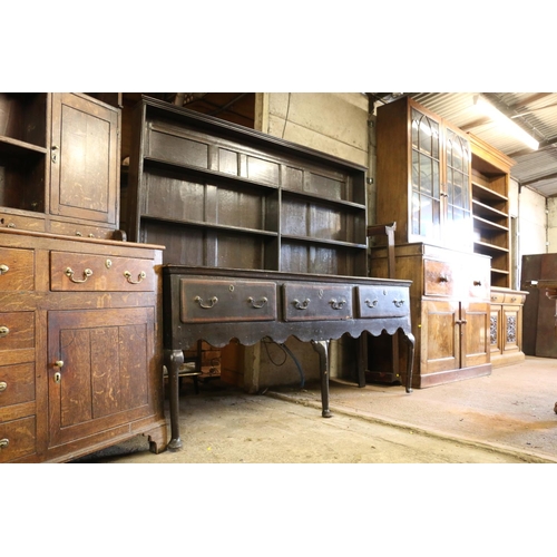 646 - 18th century dresser, the panelled plate rack over base with three drawers, shaped apron, raised on ... 