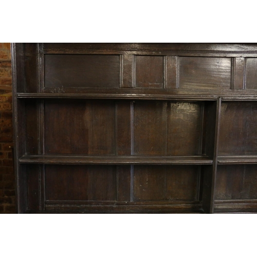 646 - 18th century dresser, the panelled plate rack over base with three drawers, shaped apron, raised on ... 