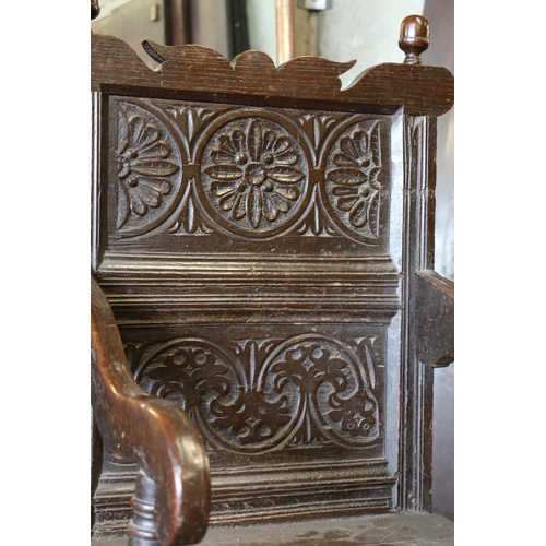 648 - 17th century wainscot chair, the foliate carved panel back with acorn finials, above solid seat, sha... 