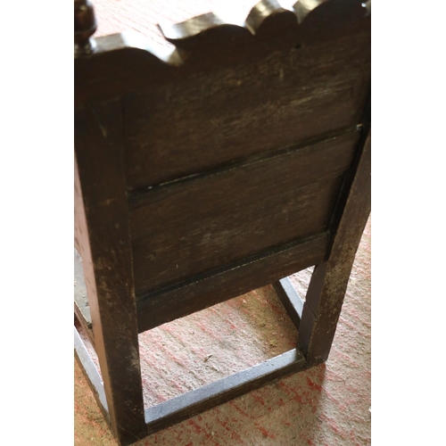 648 - 17th century wainscot chair, the foliate carved panel back with acorn finials, above solid seat, sha... 