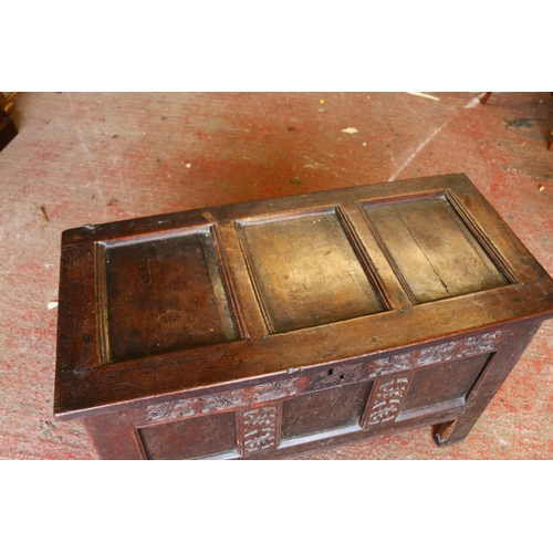 652 - 17th century oak coffer, the panelled top on later hinges, interior with candle box lacking lid, fro... 