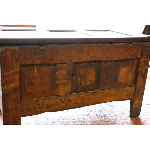 652 - 17th century oak coffer, the panelled top on later hinges, interior with candle box lacking lid, fro... 