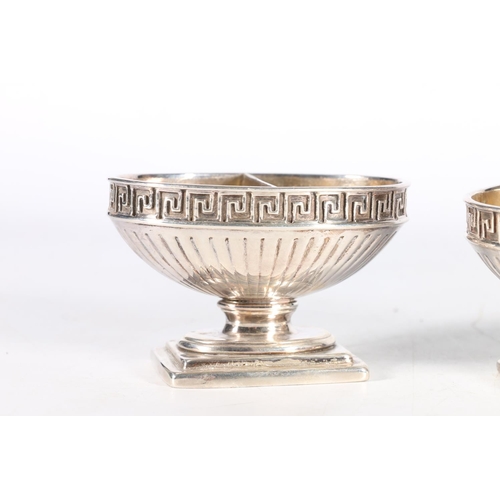 38 - Set of four heavy gauge cast silver tables salts with Greek key borders, no hallmarks, 647g gross. (... 