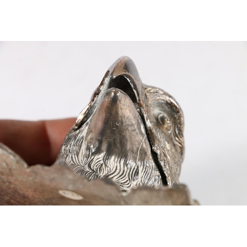 40 - Silver plated cast metal inkwell in the form of an eagle's head, 7cm tall, the base 8.5cm x 8cm.