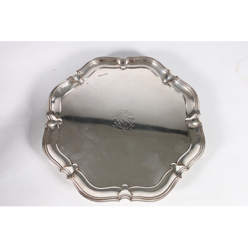 50R - George V silver salver with pie crust edge raised on four squat feet by Atkin Brothers, Sheffield 19... 