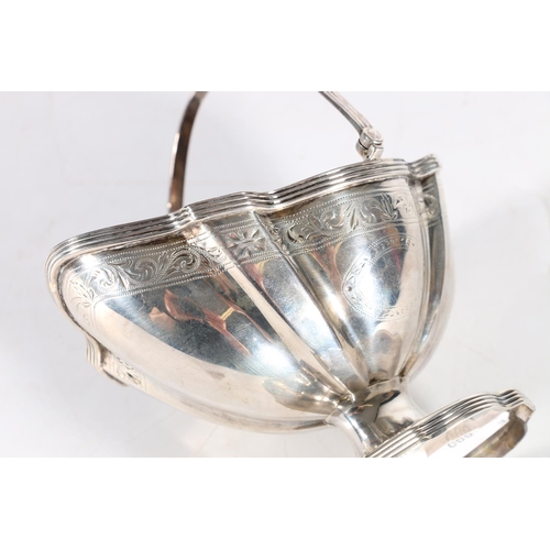 52 - Georgian silver swing handled sugar basket of fluted oval shape, makers marks over stamped, London 1... 