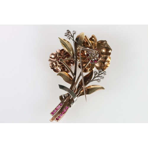 214 - Unhallmarked yellow metal floral bouquet brooch set with rubies and diamonds, 27g gross, 8cm long.