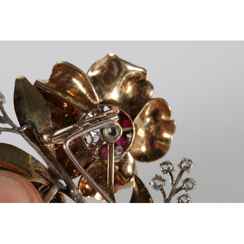 214 - Unhallmarked yellow metal floral bouquet brooch set with rubies and diamonds, 27g gross, 8cm long.