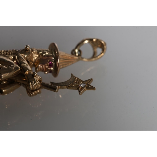 215 - 9ct gold pendant in the form of a witch on broomstick, her eyes and back picked out in gemstones, th... 