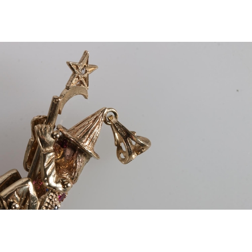 215 - 9ct gold pendant in the form of a witch on broomstick, her eyes and back picked out in gemstones, th... 