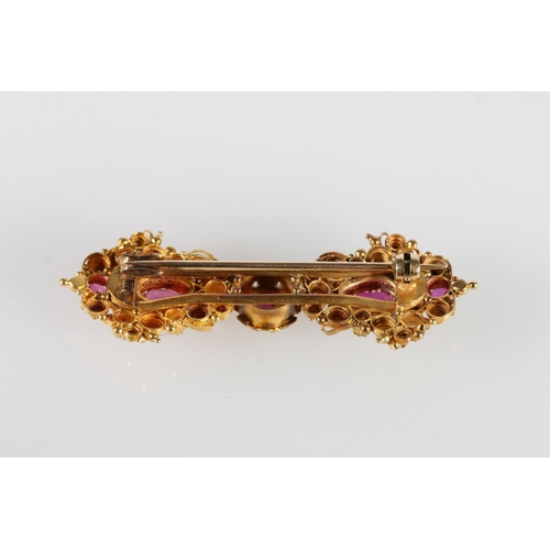 228 - Unhallmarked yellow metal diamond and ruby bar brooch with filigree work, 11g gross.