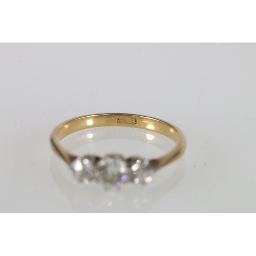 239 - 18ct yellow gold diamond three-stone ring, the central diamond approximately 0.25cts flanked by two ... 