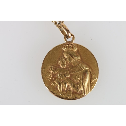 96 - Yellow metal religious pendant, one side with an angel, the other with mother and child, 12g gross.