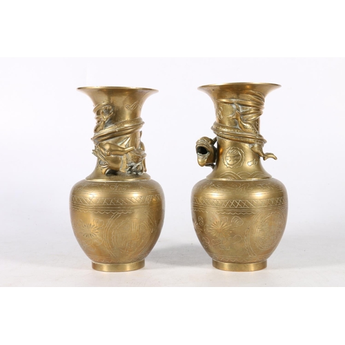 385A - Pair of late 19th century oriental brass vases, with dragon design and engraved motifs, 19cm.