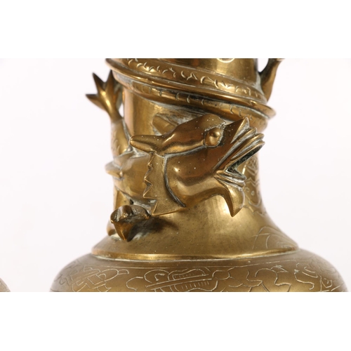 385A - Pair of late 19th century oriental brass vases, with dragon design and engraved motifs, 19cm.