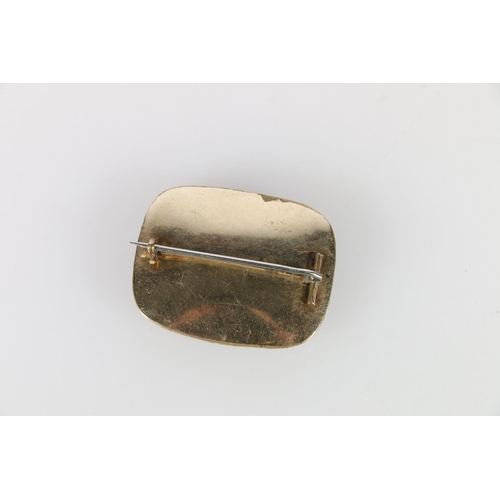 565A - Georgian mourning brooch, with black enamel and hair within beveled glass frame, 4 x 3 cm.