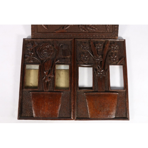 580A - Two Scottish Art Nouveau stylised oak photograph panels depicting carved foliage within jardinieres,... 