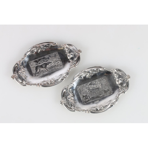 620A - Pair of Scottish Art Nouveau silver dishes decorated with country scenes of thistles, stag and dog, ... 