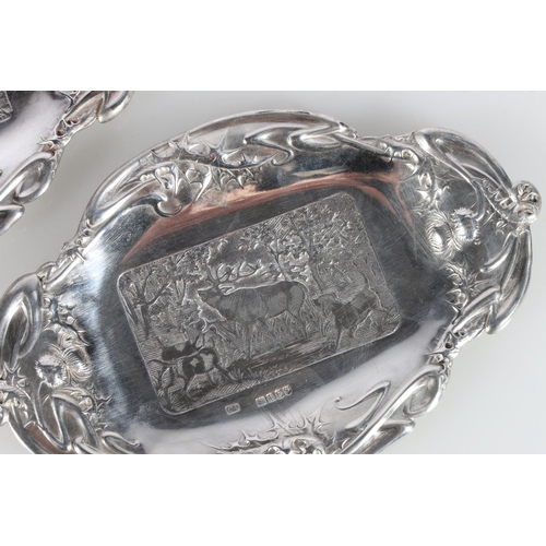 620A - Pair of Scottish Art Nouveau silver dishes decorated with country scenes of thistles, stag and dog, ... 