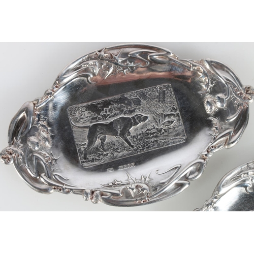 620A - Pair of Scottish Art Nouveau silver dishes decorated with country scenes of thistles, stag and dog, ... 