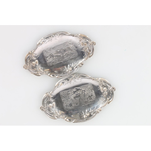 620A - Pair of Scottish Art Nouveau silver dishes decorated with country scenes of thistles, stag and dog, ... 