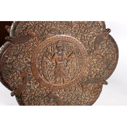 65A - African hardwood side table, with central carved ceremonial figure and carved crocodiles, raised on ... 