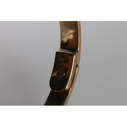 121 - 9ct gold bangle with screw head decoration, maker's mark not discernible, the piece is well-made and... 