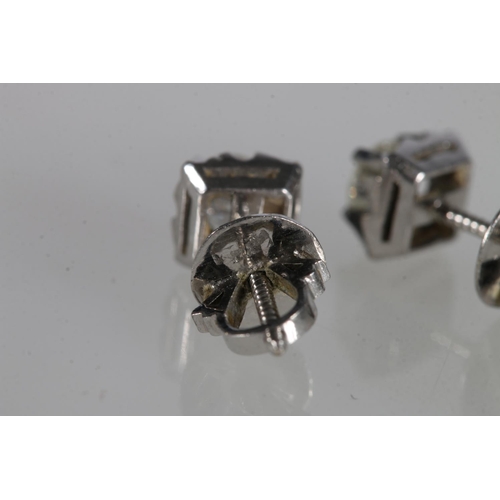 204 - Pair of unhallmarked white metal ear-studs, each set with 0.25ct diamonds, 1.89g gross.