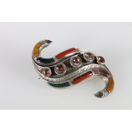 77 - Unhallmarked silver Scottish pebble set brooch of recurved from set with agates and five faceted sto... 