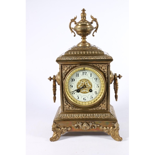 379 - French gilt brass striking mantle clock of architectural form with urn finial, the white enamel dial... 