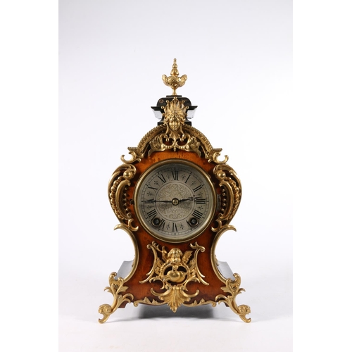 384 - German ormolu mounted mantle clock in the French Rococo style, the silvered dial with Roman numeral ... 