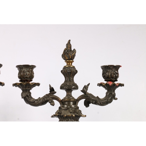 375 - Pair of 19th c. bronze candelabra  with flame finials, flanked by two arm candleholders, on scrollin... 